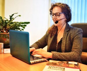 Student sitting on laptop taking part in online language lessons
