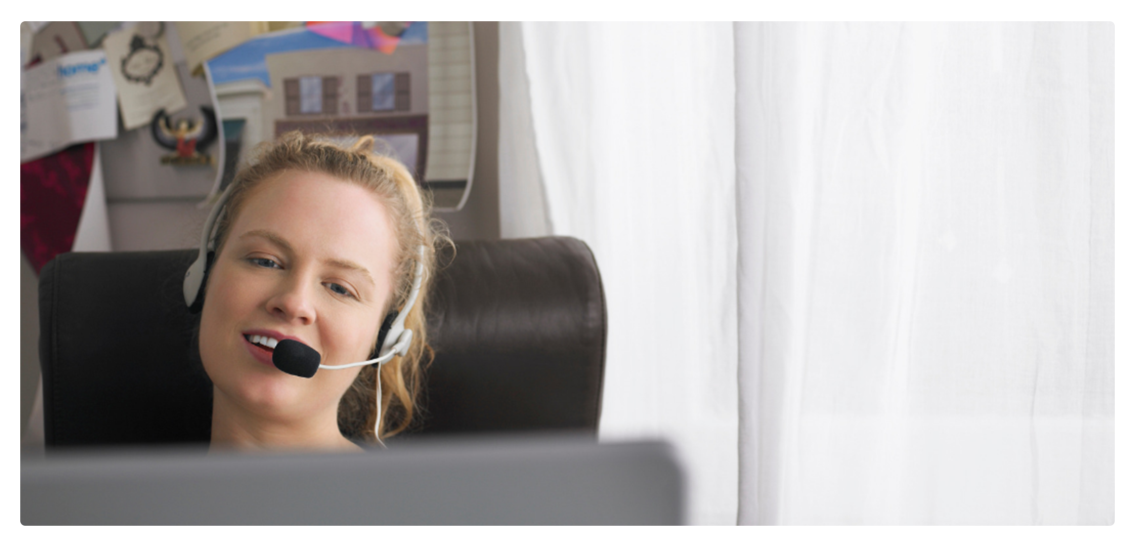 A picture of a woman talking to someone via Skype. She's teaching one of our online language courses. 