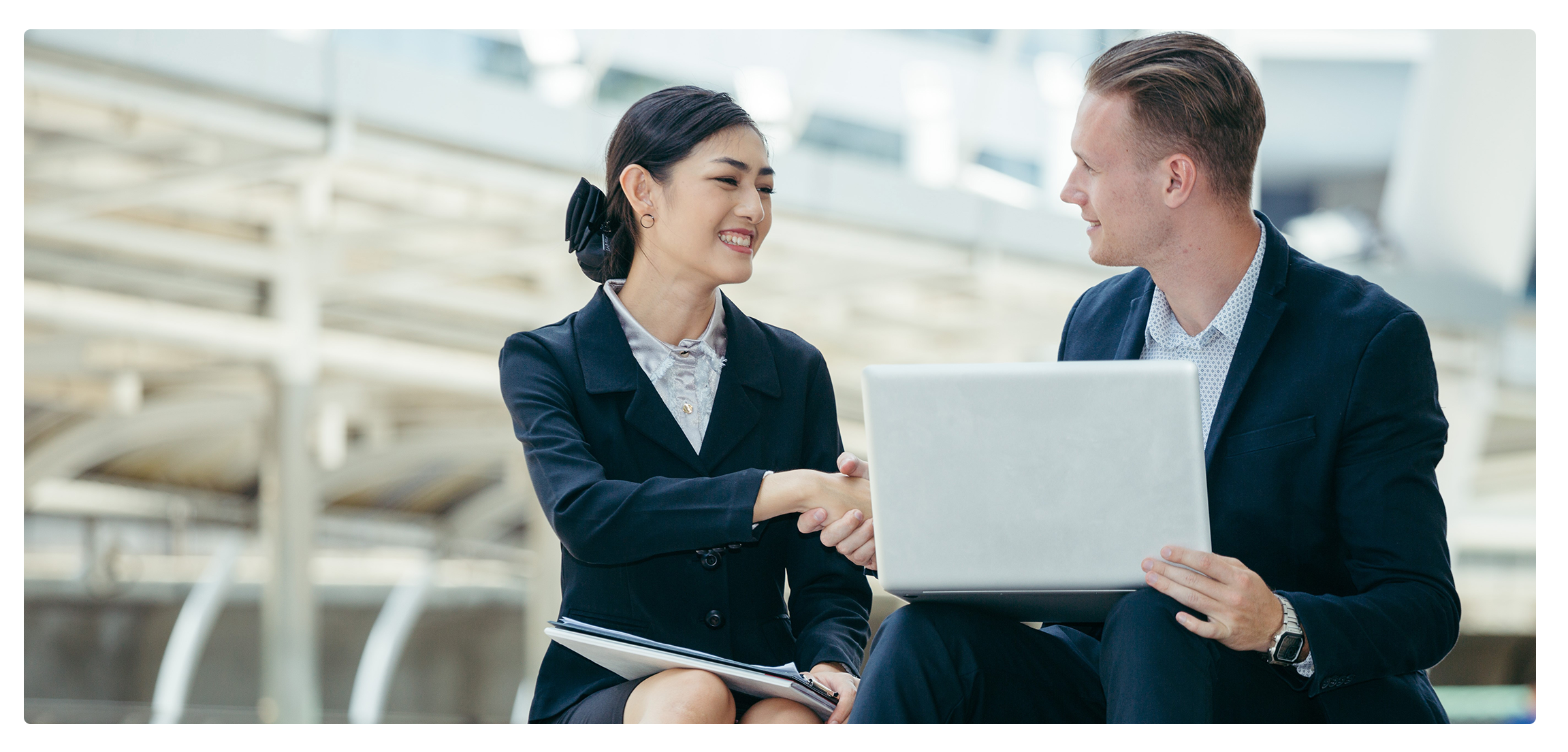 Picture of two people shaking hands, having taken RLI's cross-cultural training